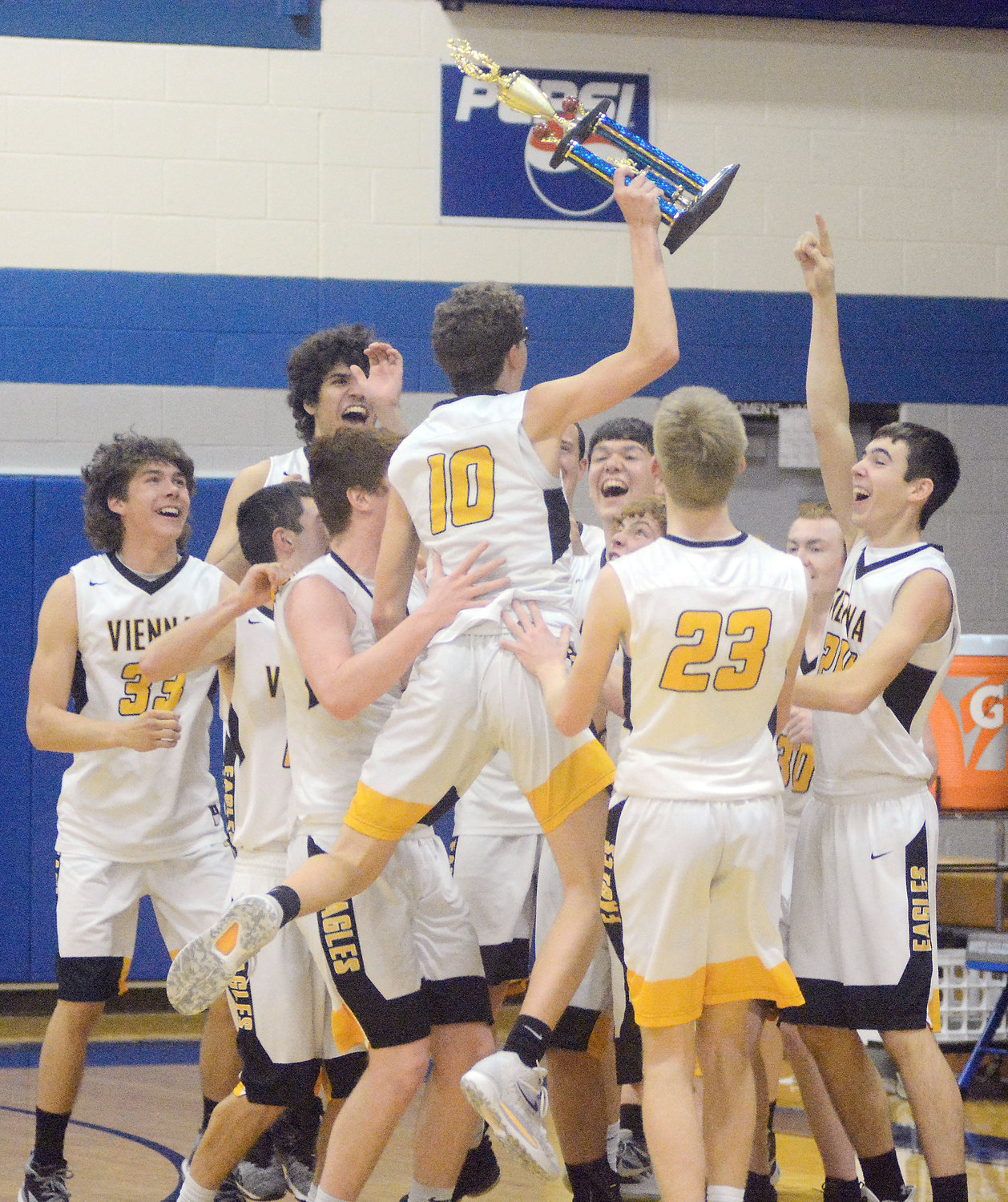 Max Steffen (center) leaps with the championship trophy in hand while celebrating Vienna’s first tournament title in four years.
